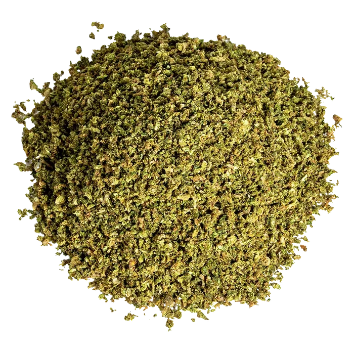 Top-down view of a loose green herb pile labeled Space Cake Milled.