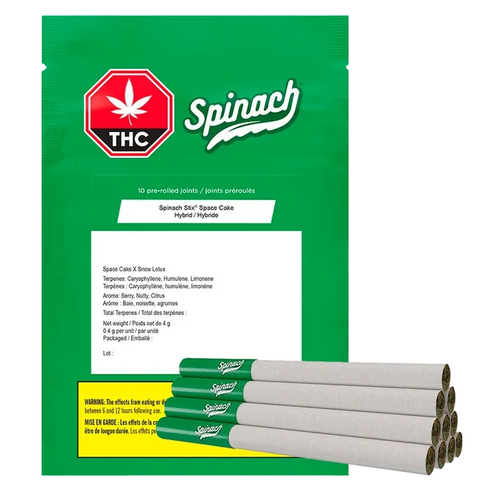 Front-facing green package with a red THC octagon and "Spinach" logo, the "STIX Space Cake PR 10 x 0.4 g" bag shown with a stack of green‑tipped pre-rolls at the lower right.
