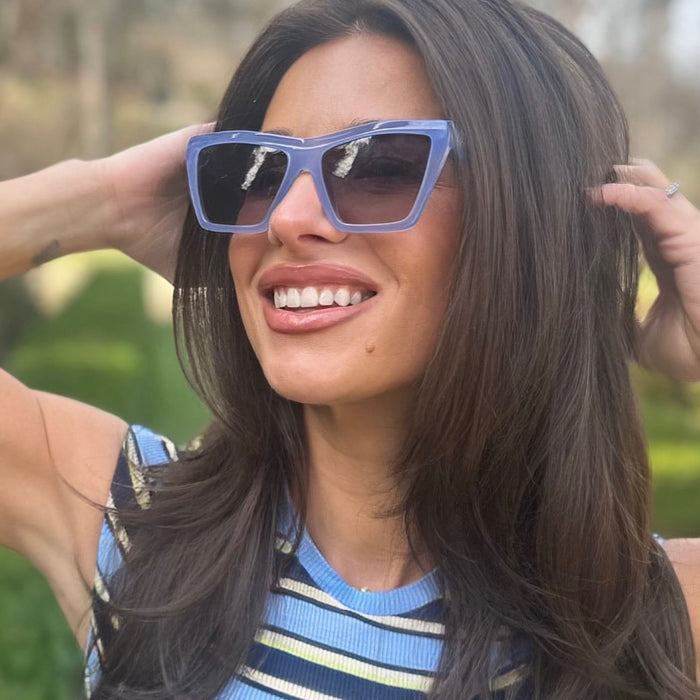 on model - jessie james decker wearing diff eyewear vivi cateye sunglasses with a milky blue pearl frame and grey gradient lenses angled view
