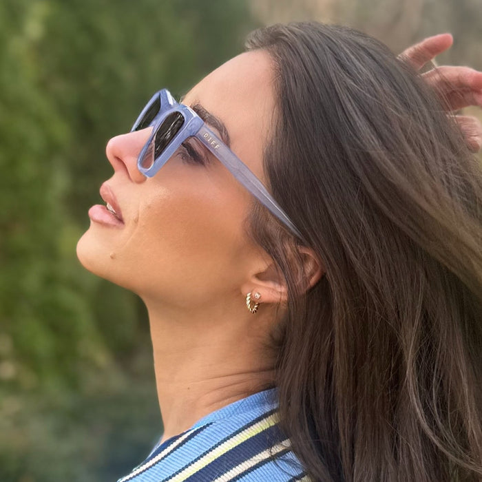on model - jessie james decker wearing diff eyewear vivi cateye sunglasses with a milky blue pearl frame and grey gradient lenses side view