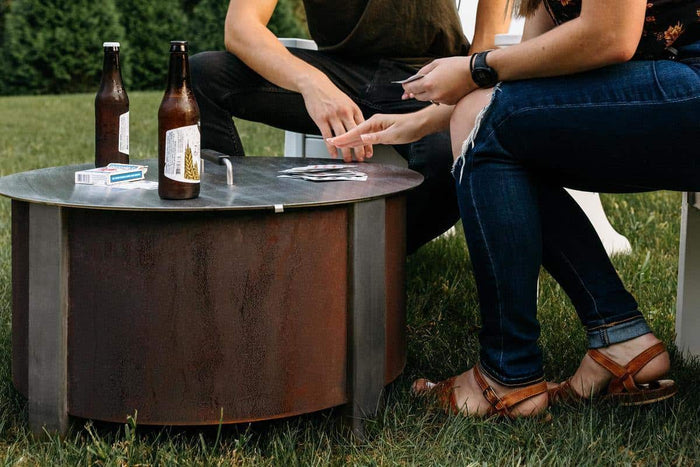 Playing a card game on the lid of an X Series firepit lid